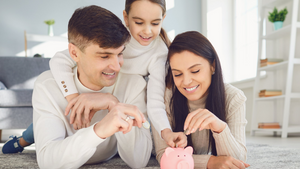 family playing with piggy bank together
