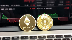 Bitcoin and Ethereum coins resting on computer