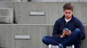 person sitting using cellphone